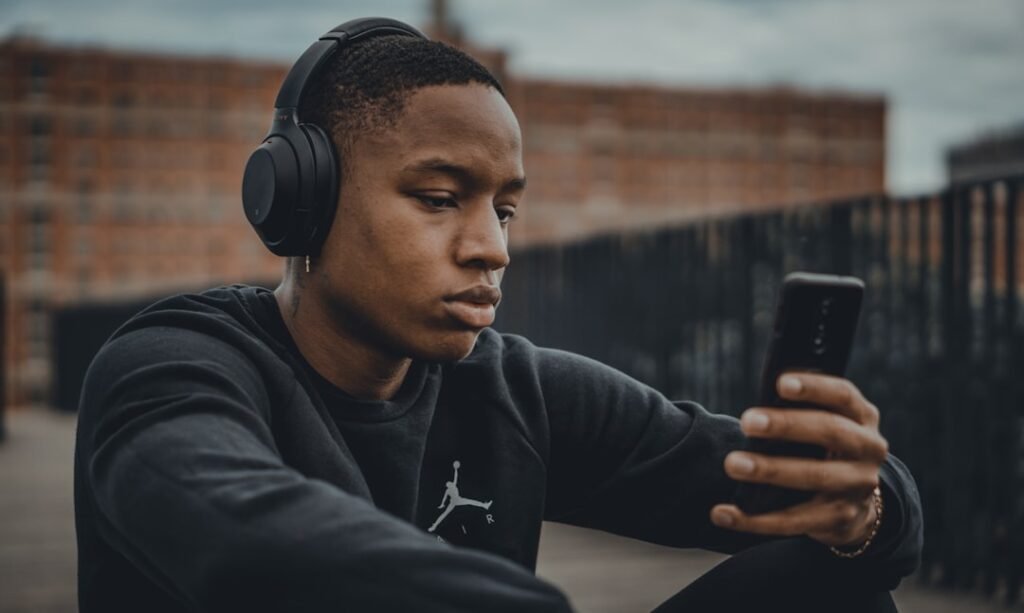 Person using headphones with a smartphone for Bluetooth connection troubleshooting
