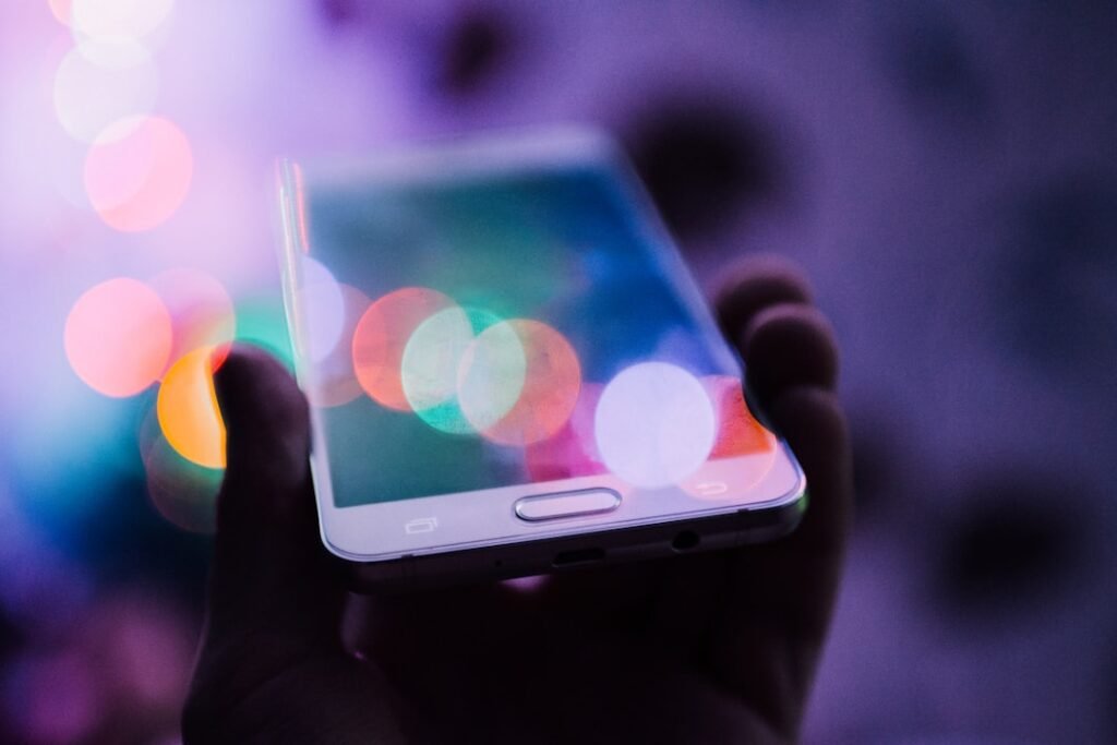 Person holding a smartphone for battery drain troubleshooting