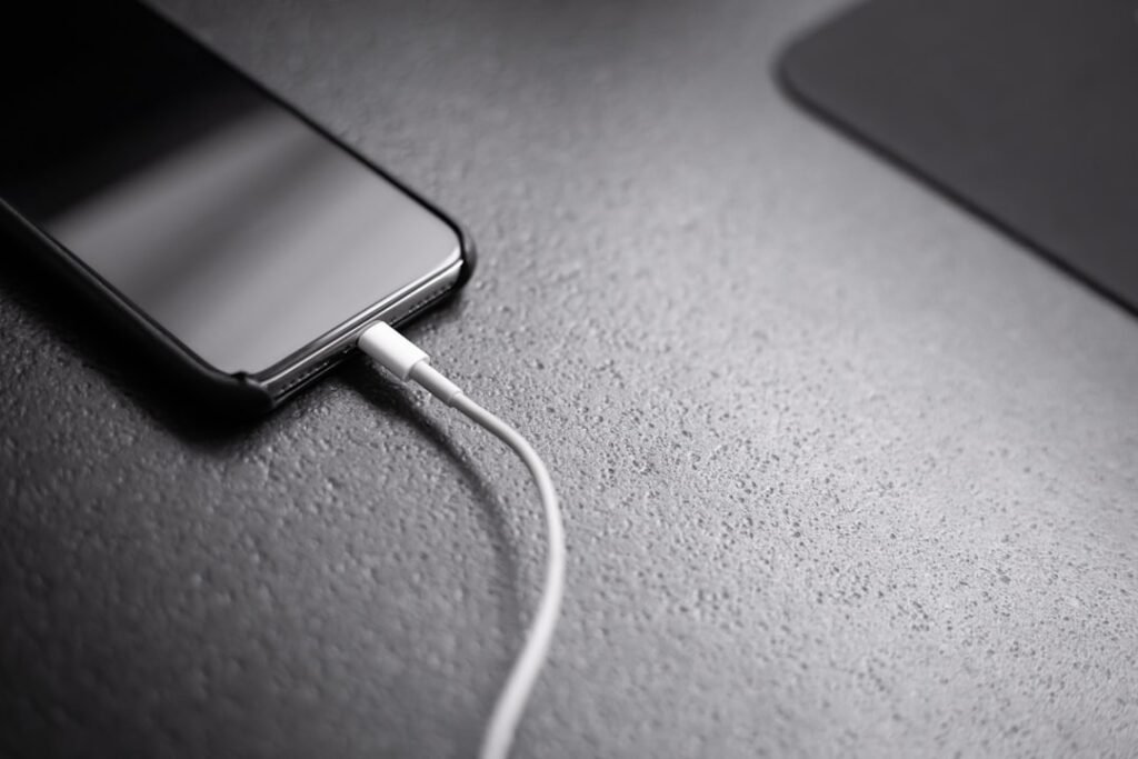 Smartphone connected to a charger for slow charging troubleshooting