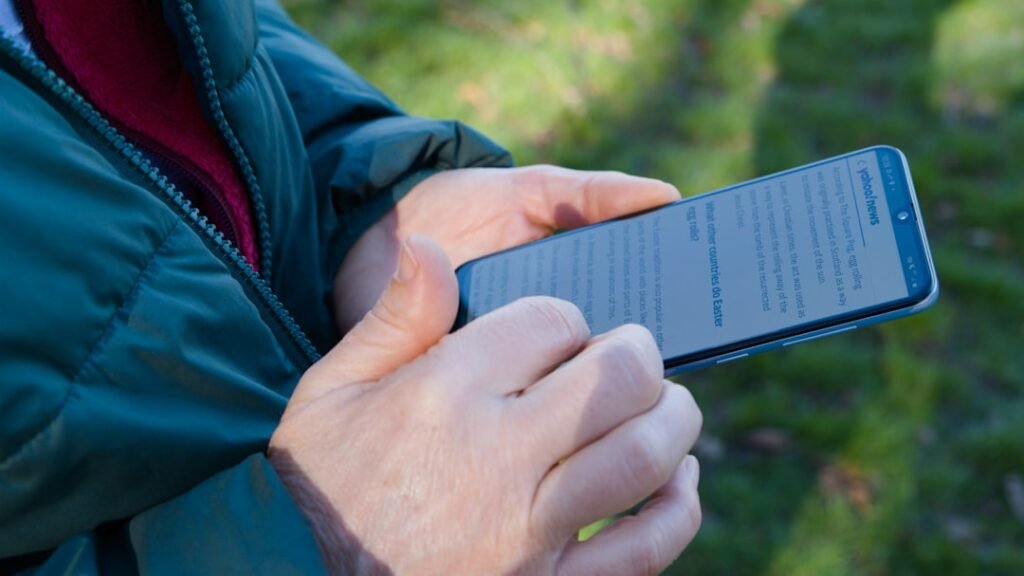 Smartphone in hand for overheating troubleshooting